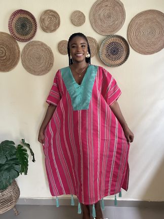 Woman wearing a pink colored Aso Oke bubu dress by ivybyivie, styled for an event
